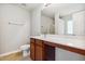 Well-lit bathroom features a sleek vanity, large mirror, and convenient toilet at 2523 Ferdinand Dr, Knightdale, NC 27545