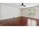 Large bedroom with hardwood floors, a ceiling fan, and a window overlooking green trees at 2523 Ferdinand Dr, Knightdale, NC 27545