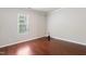 Cozy bedroom with hardwood floors and a large window providing natural light at 2523 Ferdinand Dr, Knightdale, NC 27545