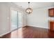 Cozy dining area with hardwood floors, a modern light fixture, and a sliding glass door to the outdoors at 2523 Ferdinand Dr, Knightdale, NC 27545