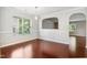 Bright dining area featuring hardwood floors, large windows, and a unique architectural cut-out at 2523 Ferdinand Dr, Knightdale, NC 27545