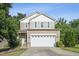 Charming two-story home with a well-maintained lawn and a two-car garage on a sunny day at 2523 Ferdinand Dr, Knightdale, NC 27545