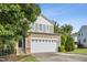 Two-story home featuring a two-car garage, complemented by professional landscaping at 2523 Ferdinand Dr, Knightdale, NC 27545