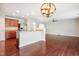 Open-concept kitchen featuring hardwood floors, stainless steel appliances, and a breakfast bar at 2523 Ferdinand Dr, Knightdale, NC 27545