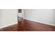 Well-lit room featuring hardwood floors, baseboard trim, and neutral-colored walls at 2523 Ferdinand Dr, Knightdale, NC 27545