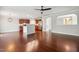 Open-concept living space with hardwood floors, a ceiling fan, and a view into the modern kitchen at 2523 Ferdinand Dr, Knightdale, NC 27545