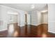Spacious living room with hardwood floors, archways, and a view into other rooms, including a half bath at 2523 Ferdinand Dr, Knightdale, NC 27545