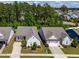 Aerial view of homes with landscaped yards and tree lined street at 2531 Impulsion Dr, New Hill, NC 27562