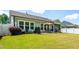 Large backyard with a patio, well-maintained lawn, and views of the home's exterior at 2531 Impulsion Dr, New Hill, NC 27562