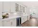 Stylish bar area with wine storage, sleek countertops, and attractive glass-front cabinets at 2531 Impulsion Dr, New Hill, NC 27562