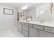 Spacious bathroom with double vanity, elegant mirrors, and a glass-enclosed shower at 2531 Impulsion Dr, New Hill, NC 27562