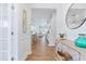 Bright hallway with hardwood floors, elegant decor, and a view into the open-concept living space at 2531 Impulsion Dr, New Hill, NC 27562