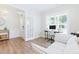 Bright home office space with hardwood floors, a white couch, and large windows at 2531 Impulsion Dr, New Hill, NC 27562