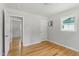 Bedroom view showing hardwood floors, an electrical panel, and doorways at 2540 Atlantic St, Durham, NC 27707