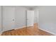 Bedroom showing an open doorway, closet, and hardwood floors at 2540 Atlantic St, Durham, NC 27707