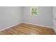 A clean and simple bedroom with hardwood floors and bright natural light at 2540 Atlantic St, Durham, NC 27707