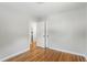 Bedroom view showing hardwood floors, an open doorway and bi-fold closet doors at 2540 Atlantic St, Durham, NC 27707