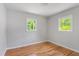 Bright bedroom features hardwood floors and two sunny windows at 2540 Atlantic St, Durham, NC 27707