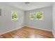 Bedroom featuring hardwood floors and bright natural light from two windows at 2540 Atlantic St, Durham, NC 27707