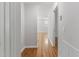 Hallway with hardwood floors and white walls leading into the house at 2540 Atlantic St, Durham, NC 27707
