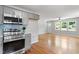 Open floor plan with a modern kitchen and stainless appliances that opens to a well-lit room at 2540 Atlantic St, Durham, NC 27707