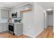 Modern kitchen offers grey cabinets, stainless steel appliances, and hardwood floors at 2540 Atlantic St, Durham, NC 27707