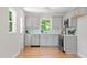 Bright kitchen boasts grey cabinets, stainless steel appliances, and hardwood floors at 2540 Atlantic St, Durham, NC 27707