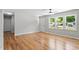 Bright living room with hardwood floors, a ceiling fan, and natural light from the three large windows at 2540 Atlantic St, Durham, NC 27707