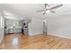 Spacious living room featuring hardwood floors, a ceiling fan, and a view to the kitchen at 2540 Atlantic St, Durham, NC 27707