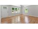 Bright living room featuring hardwood floors, a ceiling fan, and large windows at 2540 Atlantic St, Durham, NC 27707