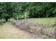 Rustic fence defines the property line beside a meadow with wildflowers at 2600 Snow Hill Rd, Durham, NC 27712