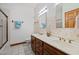 Bright bathroom with dual sinks, decorative wallpaper, tile flooring, and a shower with glass doors at 2600 Snow Hill Rd, Durham, NC 27712