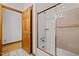 Well-lit bathroom featuring a shower-over-tub and tile flooring at 2600 Snow Hill Rd, Durham, NC 27712