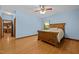 Cozy blue bedroom with hardwood floors, natural lighting, ceiling fan and a matching bed frame at 2600 Snow Hill Rd, Durham, NC 27712