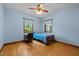 Blue bedroom with natural lighting, hardwood floors, and ceiling fan, providing a relaxing space at 2600 Snow Hill Rd, Durham, NC 27712