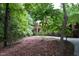 Charming brick home nestled amidst a canopy of trees with a lushly landscaped front yard at 2600 Snow Hill Rd, Durham, NC 27712