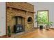 Cozy wood-burning fireplace with brick surround at 2600 Snow Hill Rd, Durham, NC 27712
