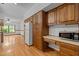 Traditional kitchen with wood cabinets, white appliances and a light-filled breakfast nook area at 2600 Snow Hill Rd, Durham, NC 27712