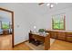 Functional office space with hardwood floors, built-in cabinets and a window offering natural light at 2600 Snow Hill Rd, Durham, NC 27712