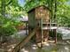 Elevated wooden playhouse in wooded back yard at 2600 Snow Hill Rd, Durham, NC 27712