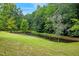 Scenic pond surrounded by lush greenery, creating a serene natural setting at 2600 Snow Hill Rd, Durham, NC 27712