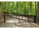 Gated property entrance surrounded by lush greenery at 2600 Snow Hill Rd, Durham, NC 27712