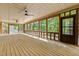 Large screened porch with wood floors and views of trees at 2600 Snow Hill Rd, Durham, NC 27712