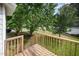 Wooden deck that overlooks green grass and mature trees for serene outdoor space at 2735 Clifton Ave, Creedmoor, NC 27522