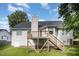 View of backyard featuring a raised deck with stairs, siding, and lush green lawn at 2735 Clifton Ave, Creedmoor, NC 27522