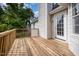 Large wood deck with white rails, white siding, and a door leading inside at 2735 Clifton Ave, Creedmoor, NC 27522