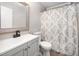 Modern bathroom featuring a vanity with basin sink and a bathtub with patterned curtain at 2735 Clifton Ave, Creedmoor, NC 27522