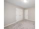 This is a bedroom with neutral walls, grey carpet, and double door closet at 2735 Clifton Ave, Creedmoor, NC 27522