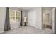 Well-lit bedroom boasting soft carpet, a window with curtains and a wardrobe closet at 2735 Clifton Ave, Creedmoor, NC 27522