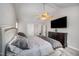 Bedroom features plush carpeting, ceiling fan, tv, and soft, neutral color palette at 2735 Clifton Ave, Creedmoor, NC 27522